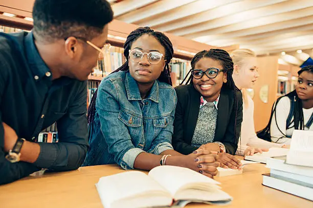 African students in collaborative study group in a library